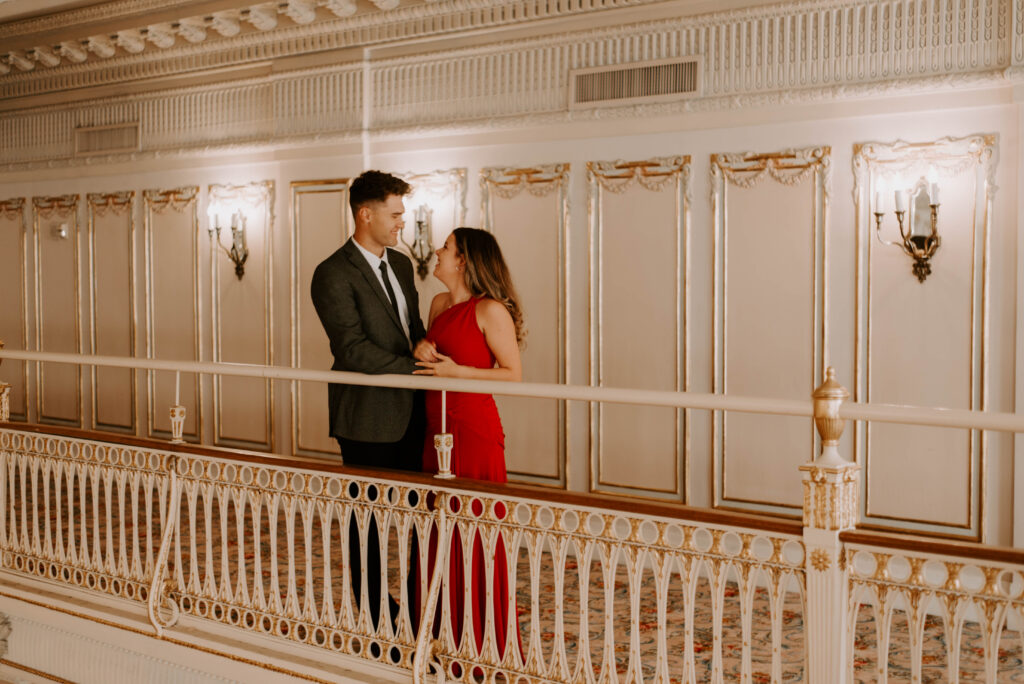 couple standing on balcony in marie antoinette ballroom in davenport hotel