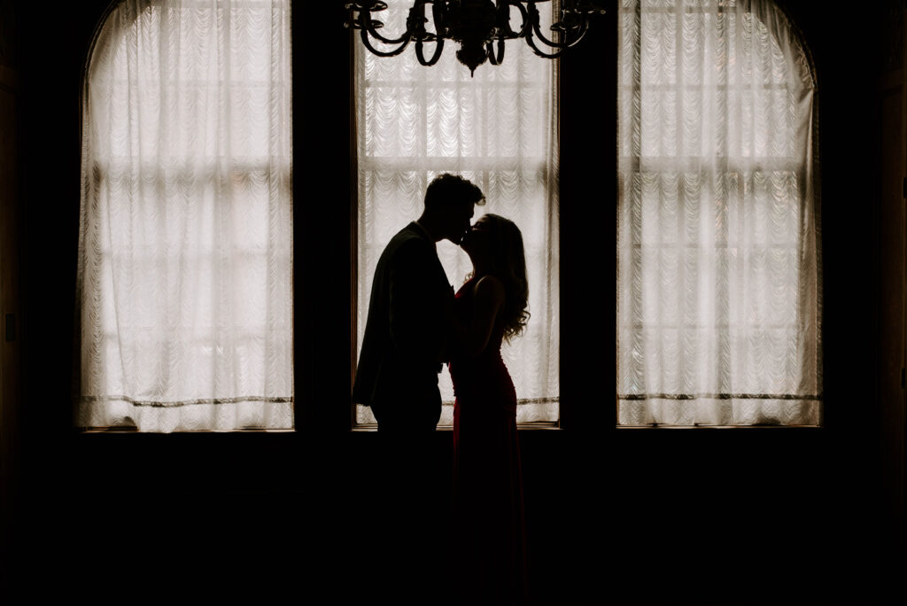 couple's silhouettes in front of window in elizabethan room in davenport hotel