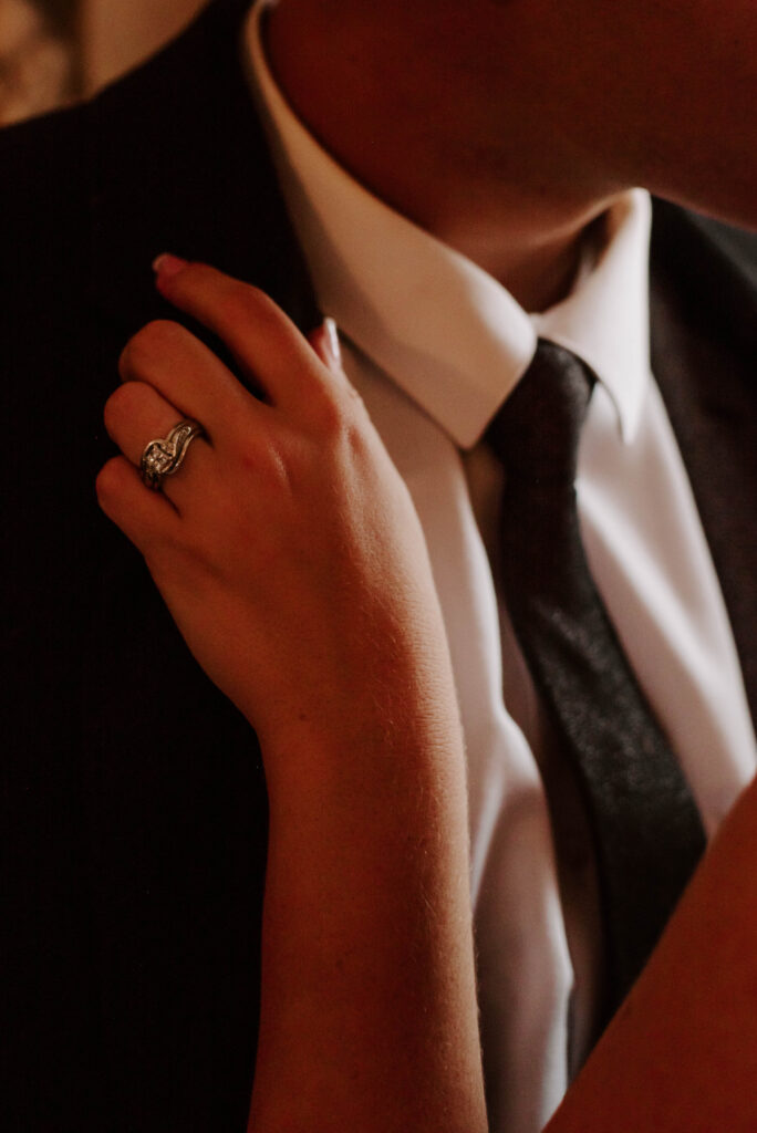 ring detail photo on groom's suit