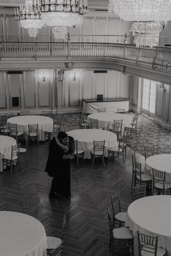 couple slow dancing under chandeliers in marie antoinette ballroom in davenport hotel