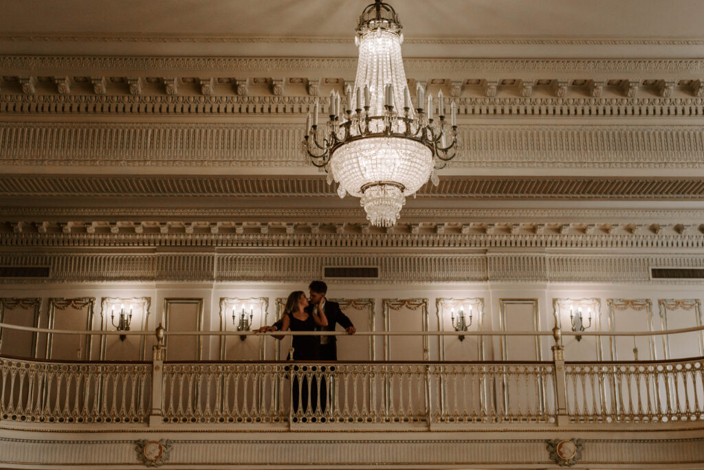 couple standing on balcony in marie antoinette ballroom in davenport hotel
