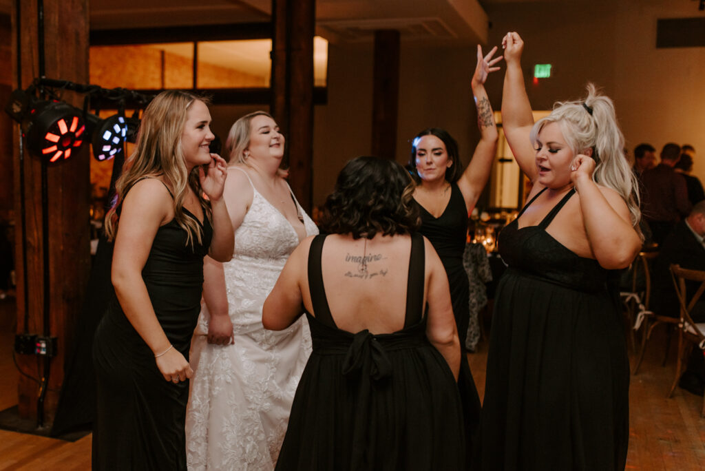 bridesmaids and bride dancing during wedding reception at the montvale event center