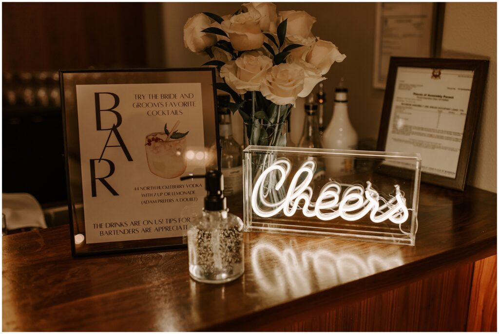 bar details for wedding reception with neon sign