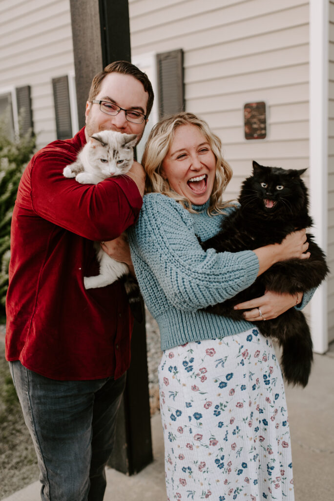 engaged couple holding their pet cats at their apartment in Spokane Washington