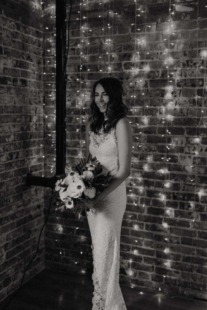 Bride laughing and holding her bouquet