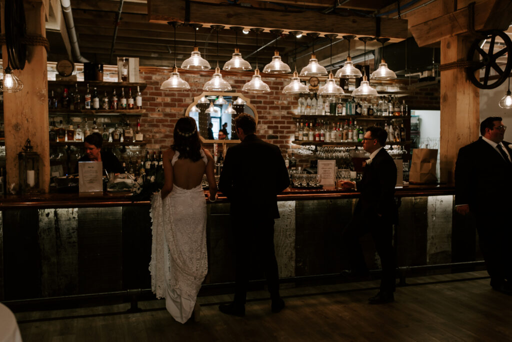 Bride and groom ordering drinks at the bar in The Boxcar Room