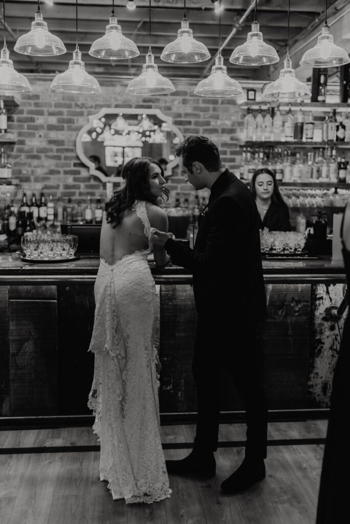 Bride and groom standing at the bar