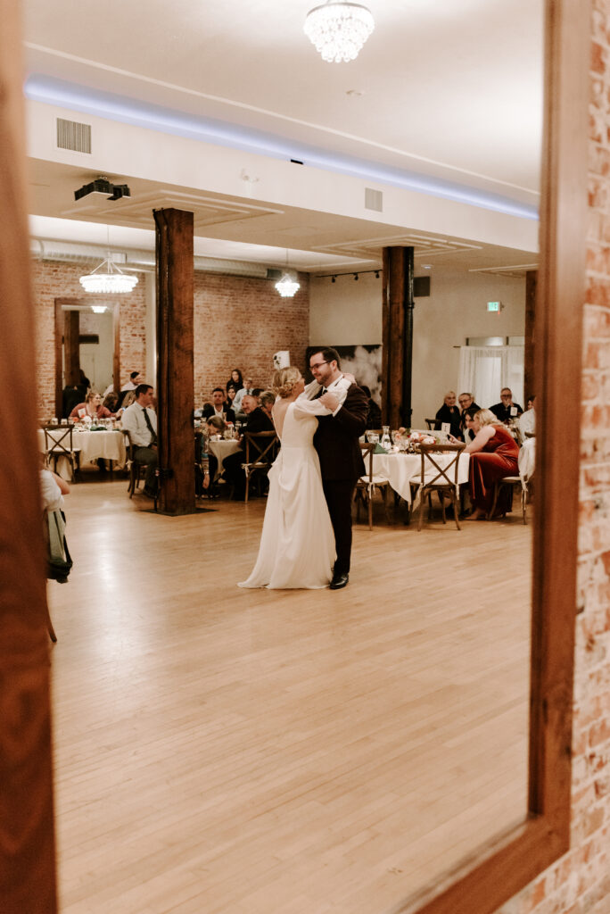bride and groom first dance in reflection of the mirror