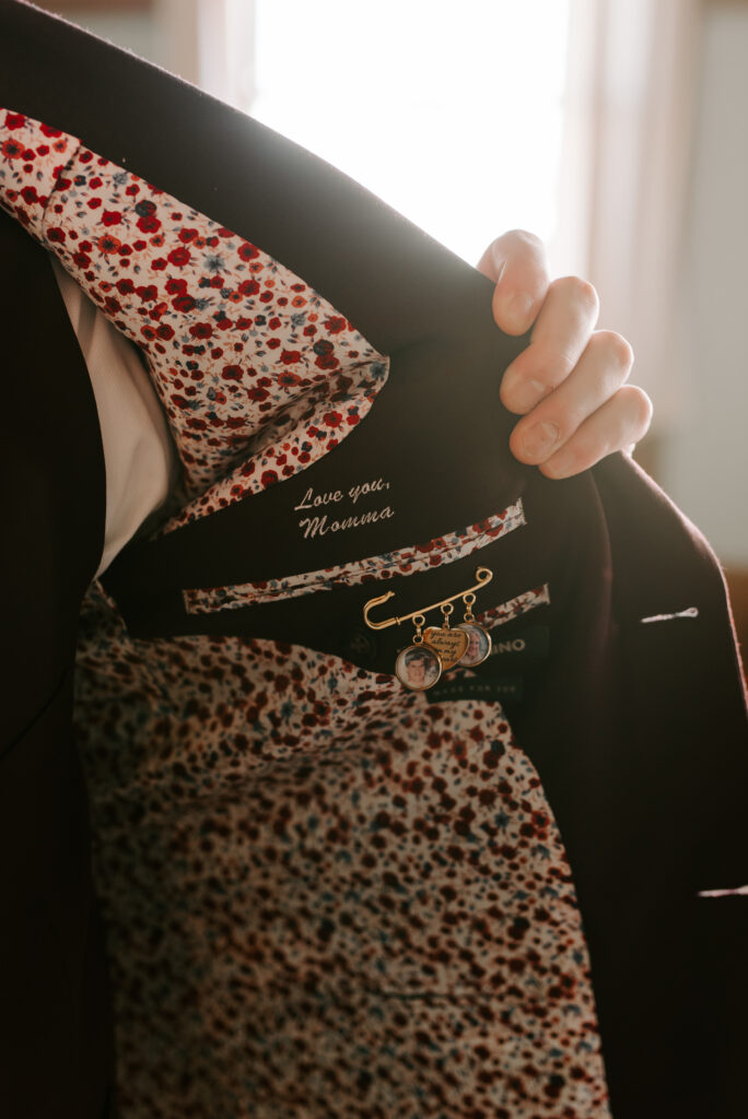 inside of groom's wedding attire with a love note and photo charms from his late mother