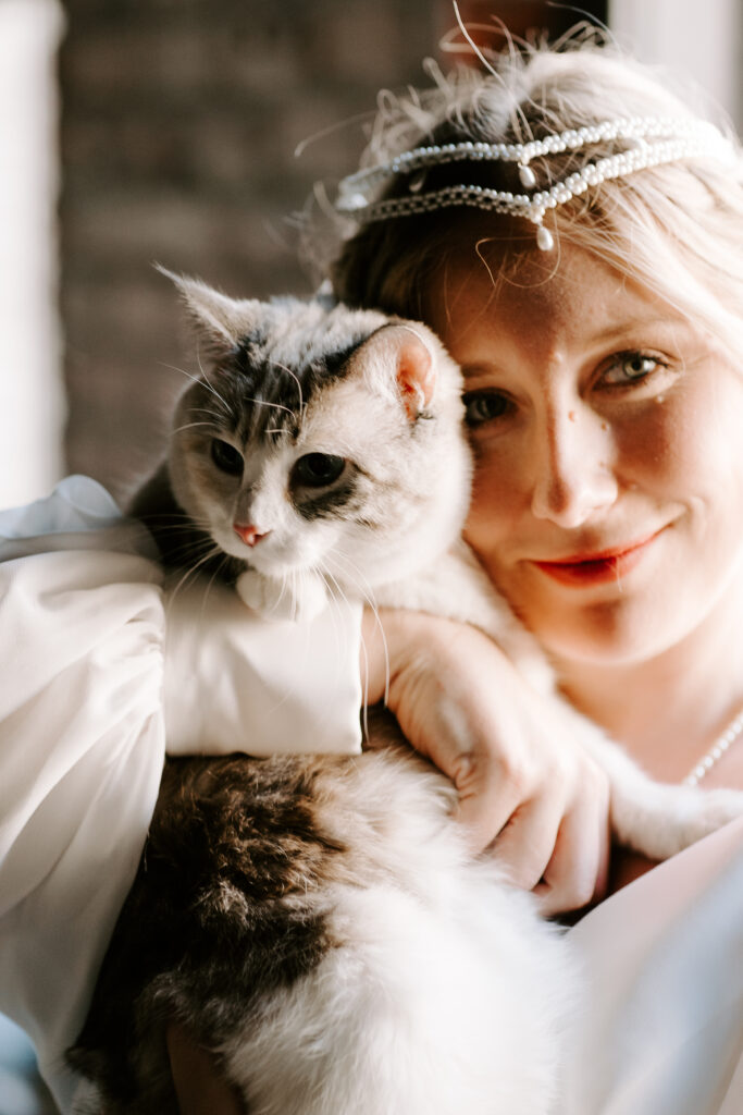 bride with her cat on wedding day