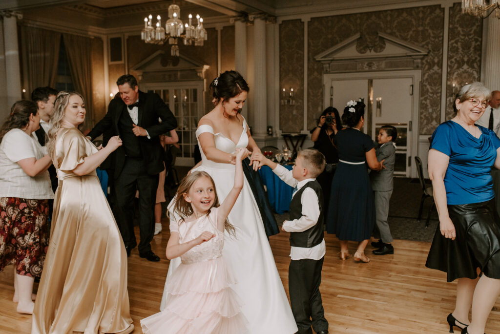 Bride dancing with kids during wedding reception