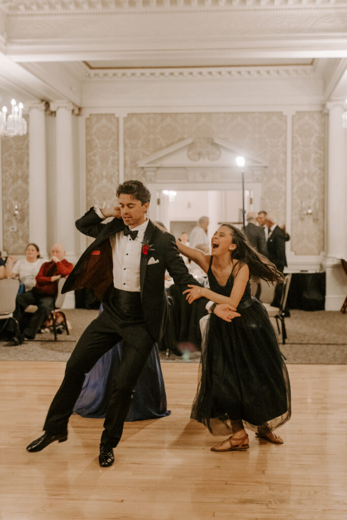 Groom dancing with niece during wedding reception