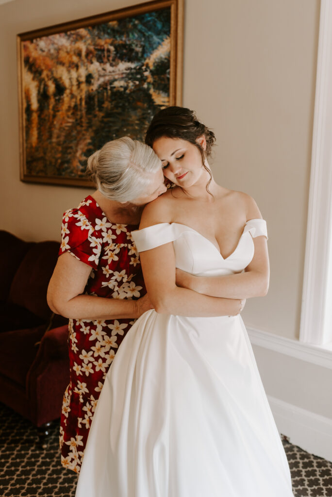 Bride and her mom having a moment together before wedding 