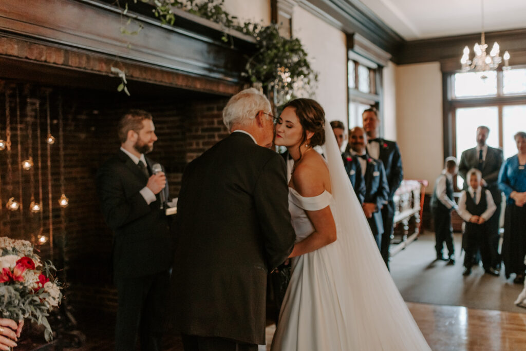 Bride's dad kissing her after walking down the aisle