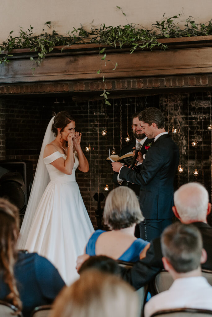 Bride crying during groom's wedding vows