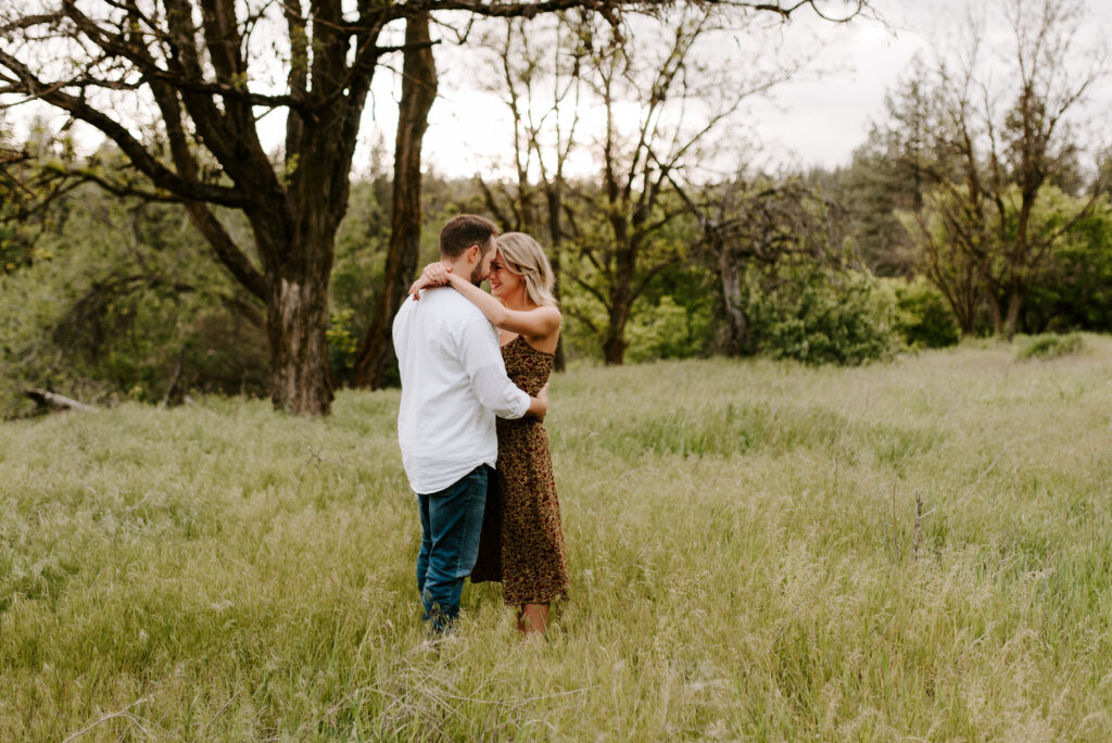 couple with the girl's arms wrapped around her fiance's neck