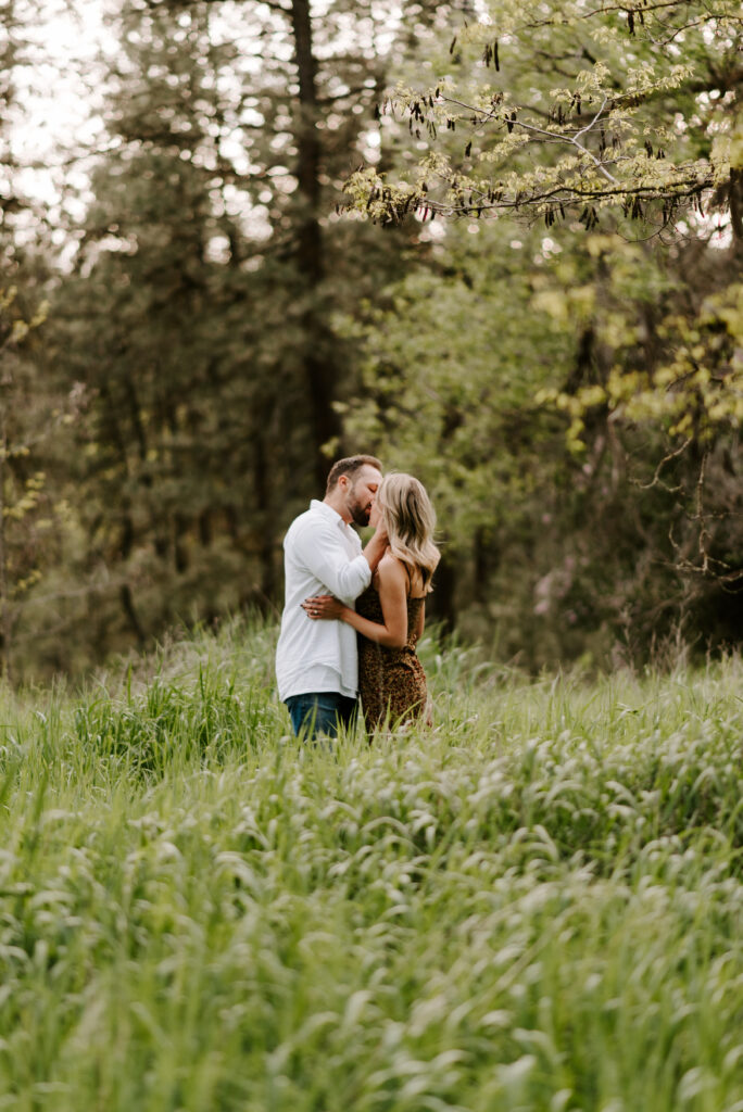 engaged couple kissing