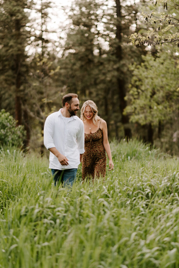 future bride and groom walking together holding hands