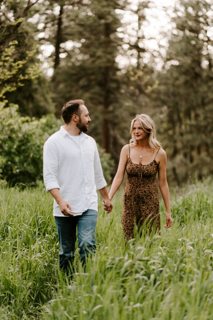 future bride and groom walking together holding hands