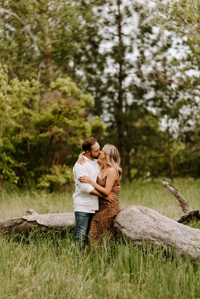 future bride and groom kissing during engagement photos