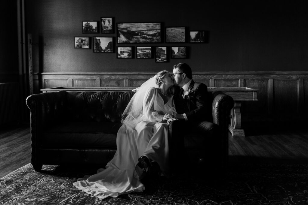 Bride and Groom sitting in the library lounge of vintage wedding venue the Montvale Event Center