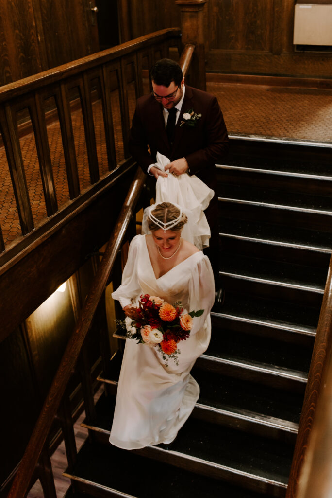 Bride and Groom walking down the stairs together