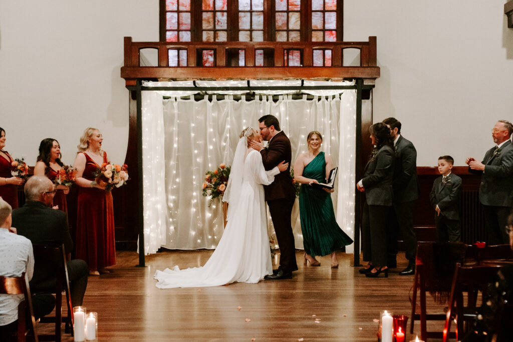Bride and Groom first kiss during wedding ceremony at vintage wedding venue Montvale Event Center