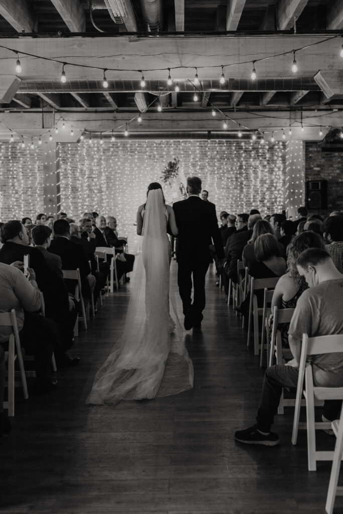 Bride and father of the Bride walking down the aisle at The Boxcar Room