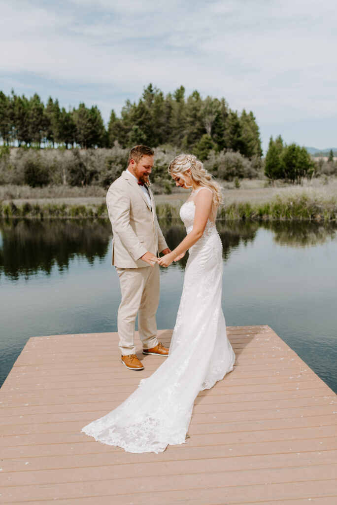 Kindsay and Noah hold hands in front of the pond after seeing each other.