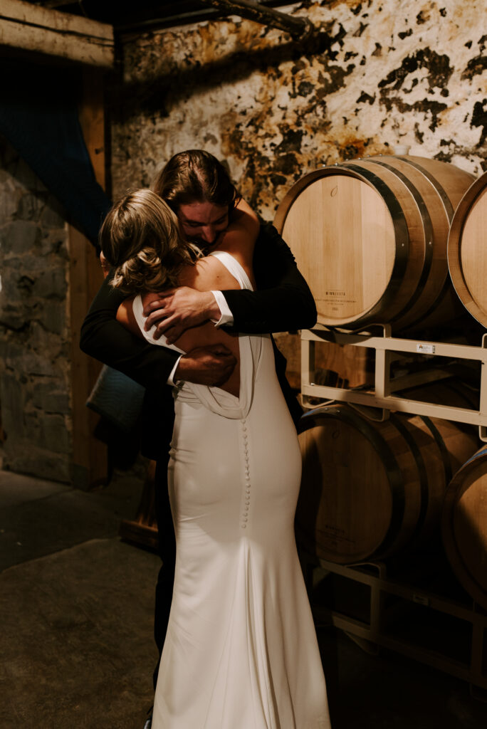 Aimee and Johnny hug each other during their first look on their wedding day.