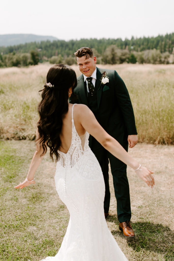 Tyler turns around to see Karina for their first look, and Karina holds her arms out to twirl around for him.