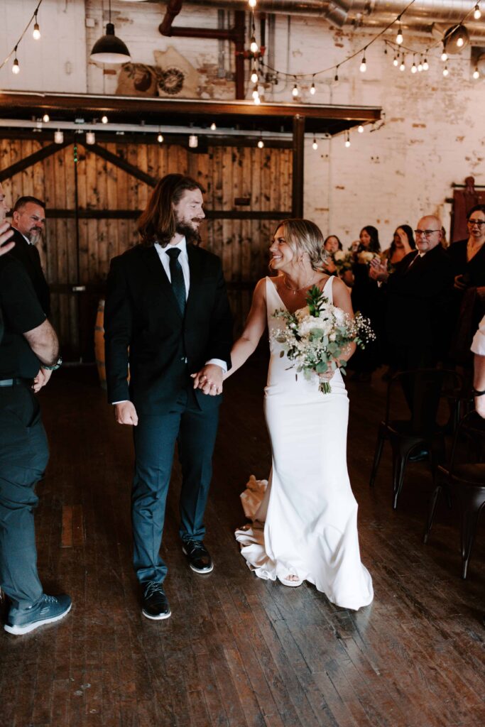 Bride and Groom walking back up the aisle.