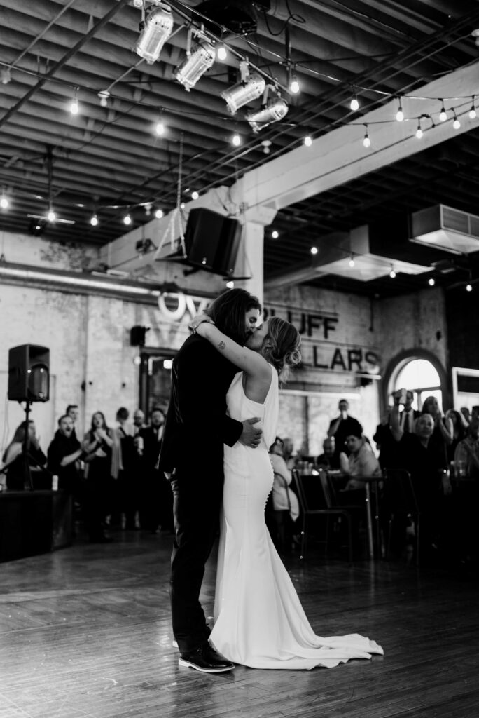 Bride and Groom kissing at the end of their first dance.