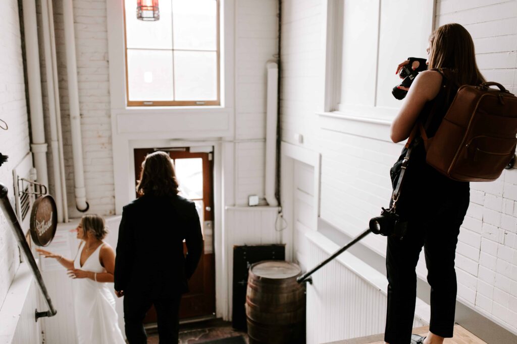 Morgan photographing the bride and groom outside of Hogwash Whiskey Den in downtown Spokane.