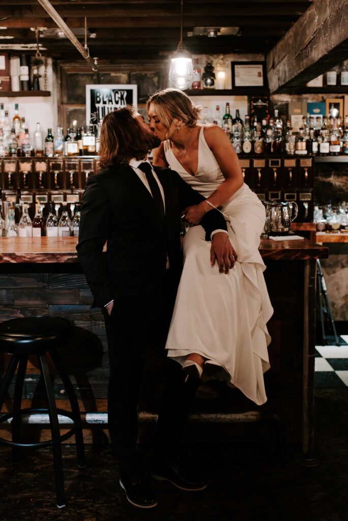 Bride and Groom kissing in Hogwash Whiskey Den.