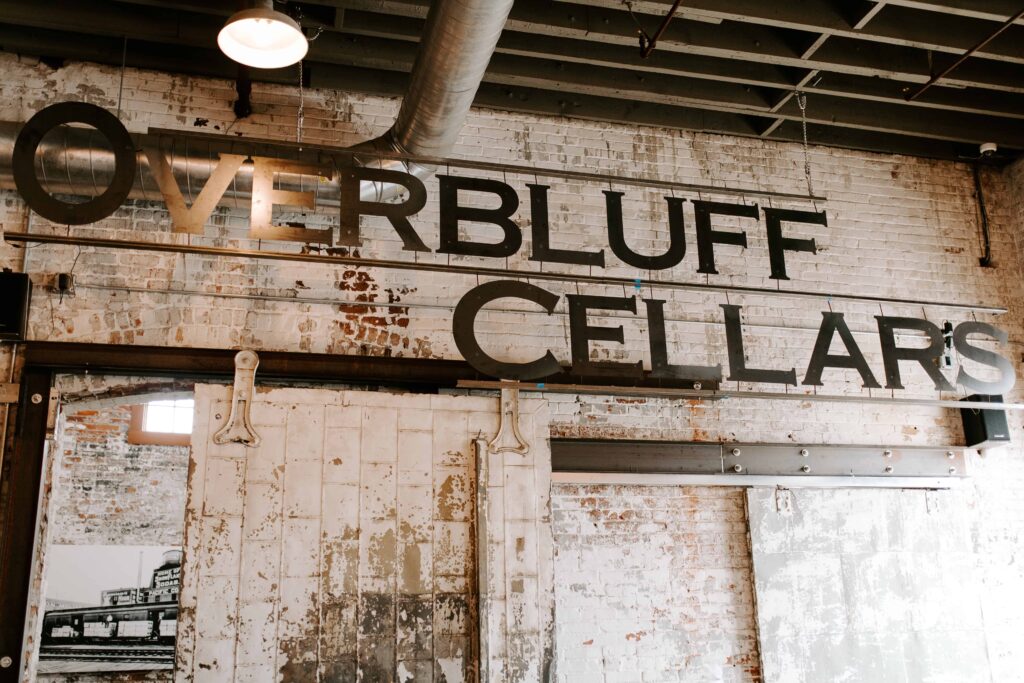 Overbluff Cellars sign hanging above the wedding venue bar. 